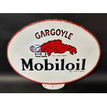 A Gargoyle Mobiloil double sided enamel advertising sign from the top of a forecourt cabinet.