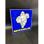 A Michelin double sided advertising sign with hanging flange depicting Mr Bibendum running towards