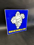 A Michelin double sided advertising sign with hanging flange depicting Mr Bibendum running towards