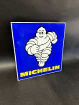 A Michelin double sided advertising sign with hanging flange depicting Mr Bibendum running towards