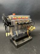 A Hornby battery-powered model of a four cylinder car engine.