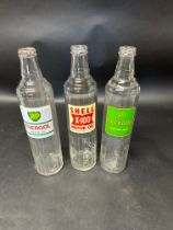 Three glass quart motor oil bottles: BP Energol (x2) and Shell X-100.