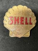 A Shell bronze cap badge with enamel lettering, by J.R. Gaunt & Son London.