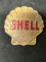 A Shell bronze cap badge with enamel lettering, by J.R. Gaunt & Son London.