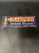 A Champion Spark Plugs 'Cost less more power' tin advertising sign, 14 3/4 x 5 1/2".