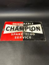 A Champion Spark Plugs enamel service sign, 1951, 23 x 13".