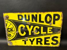A Dunlop Cycle Tyres double sided enamel advertising sign, 22 x 14" - part of an original sign.