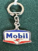 An enamel keyring advertising Mobil.