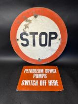 A Stop road sign and a Petroleum Spirit Pumps Switch off Here aluminium sign.