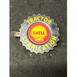 A Shell Tractor Lubrication celluloid badge.