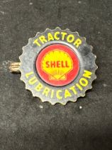 A Shell Tractor Lubrication celluloid badge.