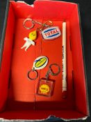 Four petrol-related keyrings and a promotional pencil: Esso, Shell, Total and Duckham's.