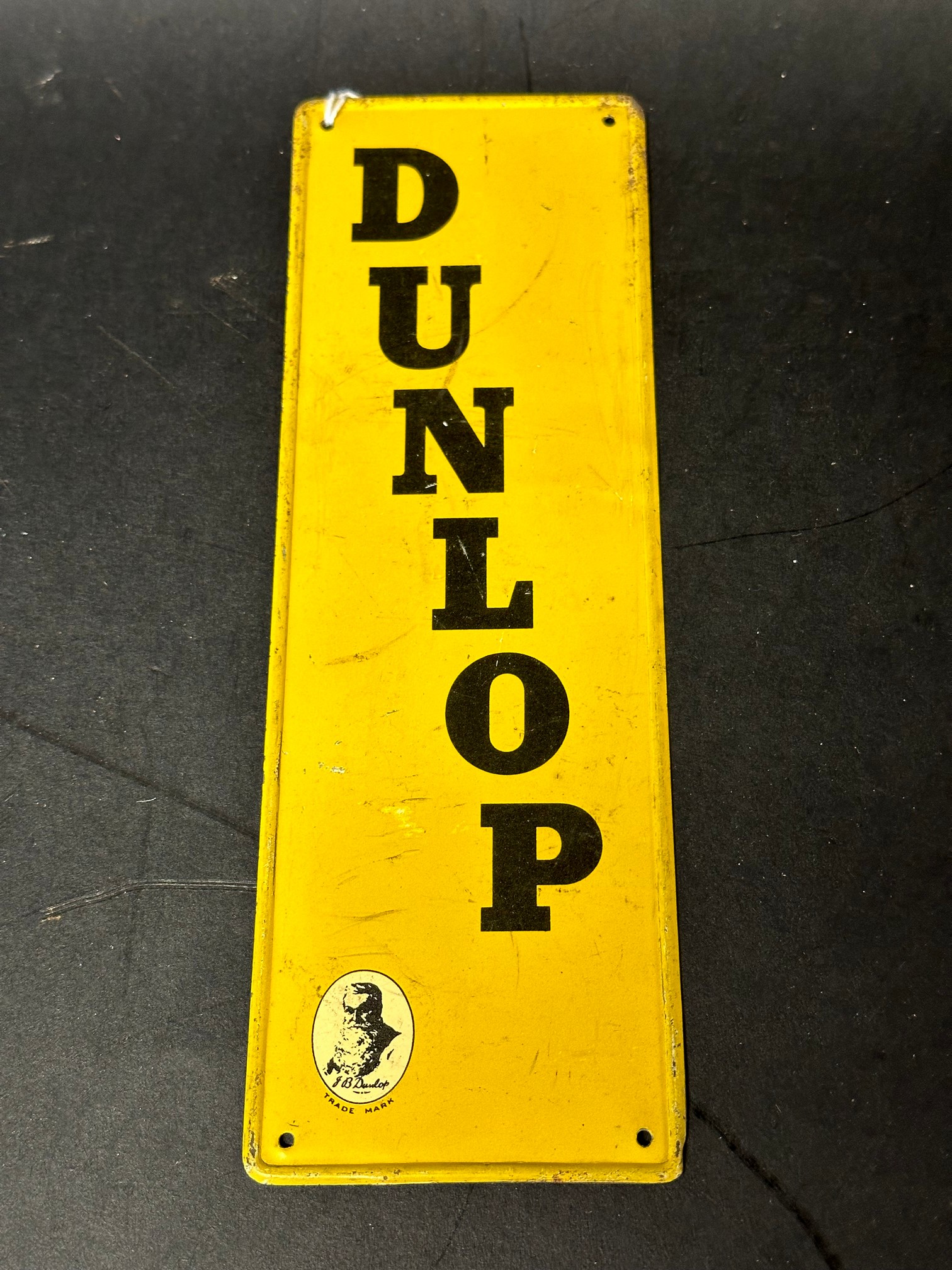 A Dunlop tin lithograph door finger plate, 3 x 9".