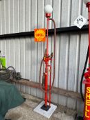 A decorative garage pump with brass t-shape nozzle on hose and Shell decals.