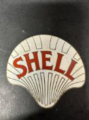A large Shell enamel cap badge.