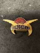 An Aeroshell badge with crescent shaped pin to verso.