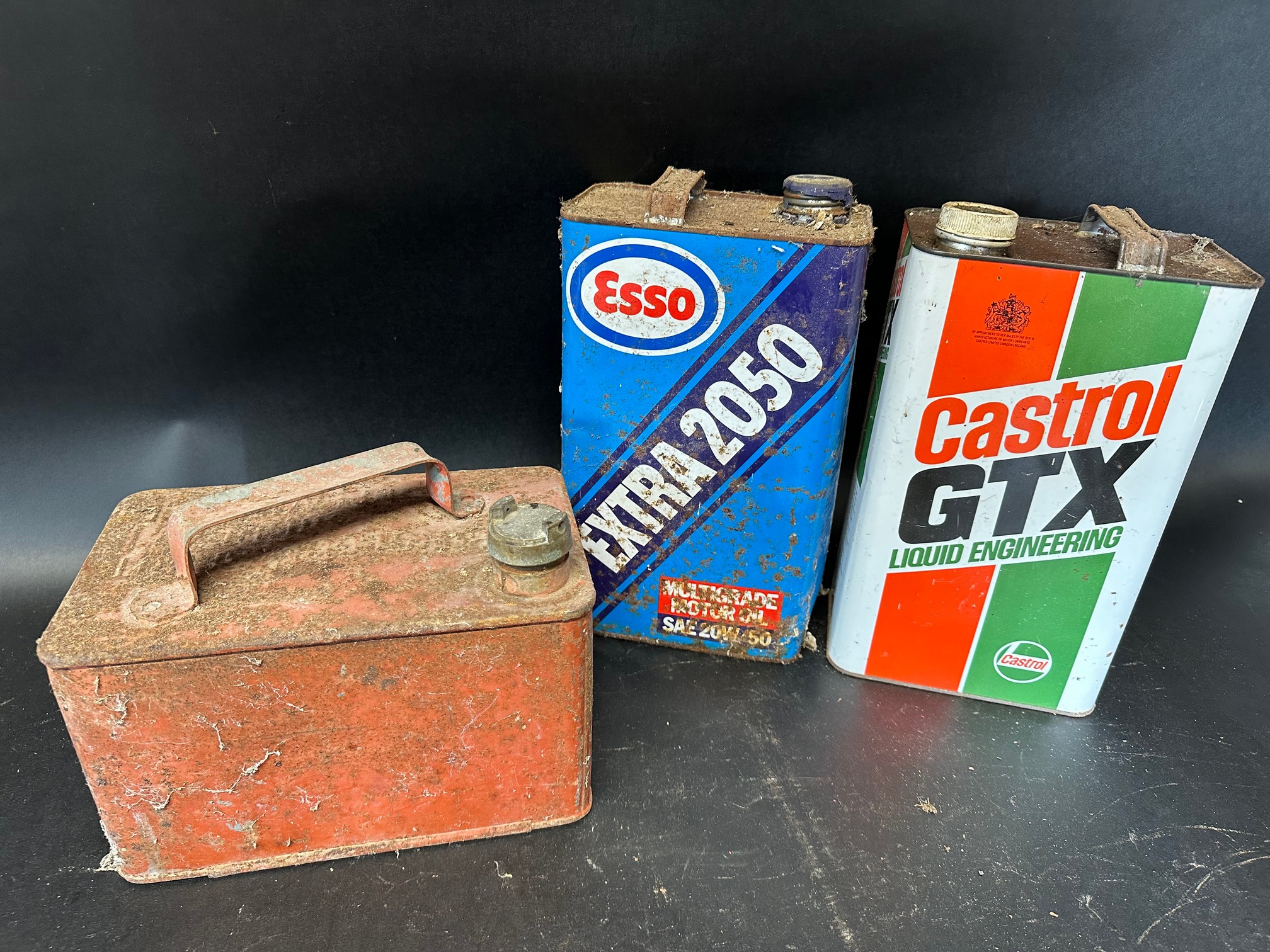 A Castrol GTX 5 litre can, an Esso Extra 2050 similar and a one gallon can with plain cap.