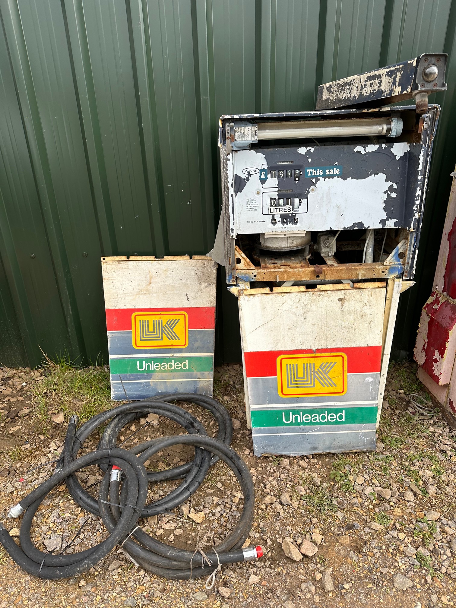 A 1970s Wayne petrol pump with UK Unleaded panels and four n.o.s hoses.