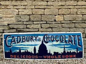 A very rare Cadbury's Chocolate pictorial enamel sign depicting a city skyline at night, by