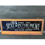 An original cobalt blue glass tram advertising sign for Scala Picture Palace, St. Deny's Rd. held