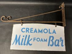 A Creamola Milk Foam Bar double sided enamel sign hanging from a wall bracket, 30 x 21"