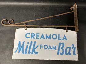A Creamola Milk Foam Bar double sided enamel sign hanging from a wall bracket, 30 x 21"