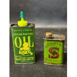 A pictorial sewing machine oil can and an early Singer oil can with cork.