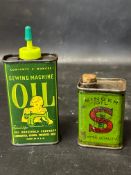 A pictorial sewing machine oil can and an early Singer oil can with cork.
