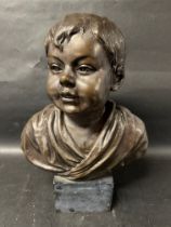 A bronze bust of a young boy, possibly used for advertising, 17 1/2" tall inc. mounting block.