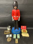 An Exclusiv Pipe Tobaccos shop display figure in the form of a beefeater plus various cigarette
