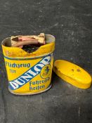A rare Dunlop cycle tin, with contents - German.