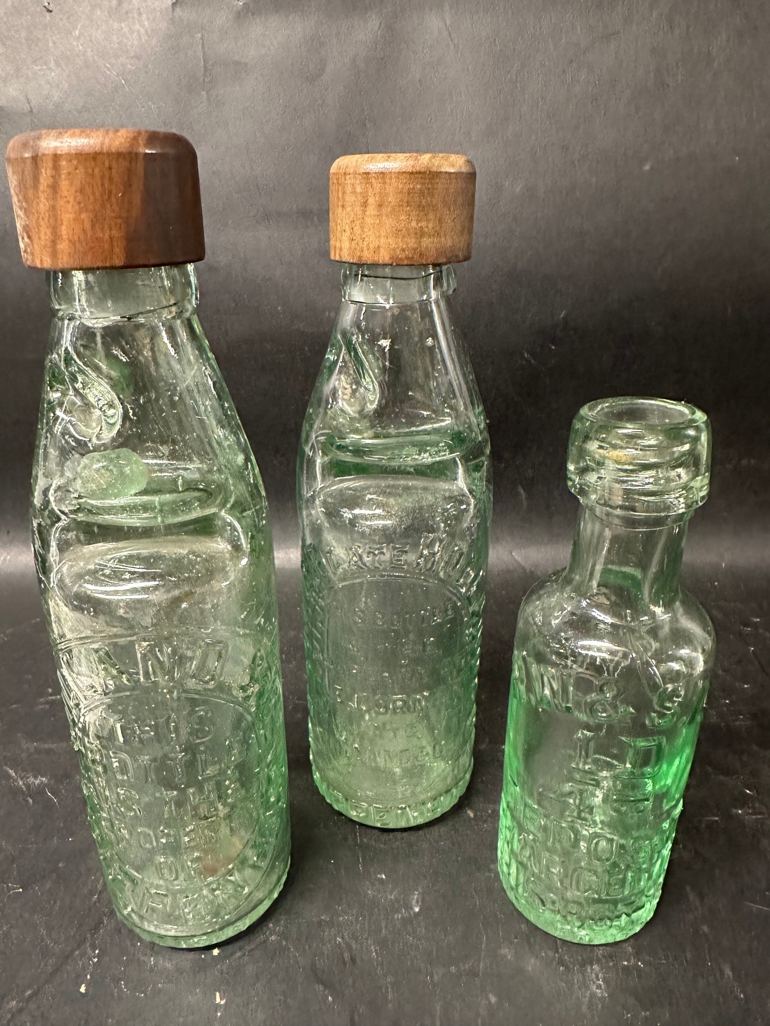 Three glass bottles: Holland & Co. Chippenham, H.E. Corner late Holland & Co.Chippenham and R.