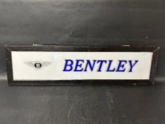 A Bentley showroom sign, perspex panel in wooden hanging frame, 39 1/2 x 10 1/2".