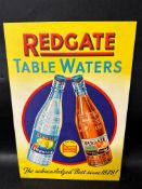 A Redgate Table Waters 'The acknowledged Best since 1878!' pictorial embossed showcard, 9 3/4 x