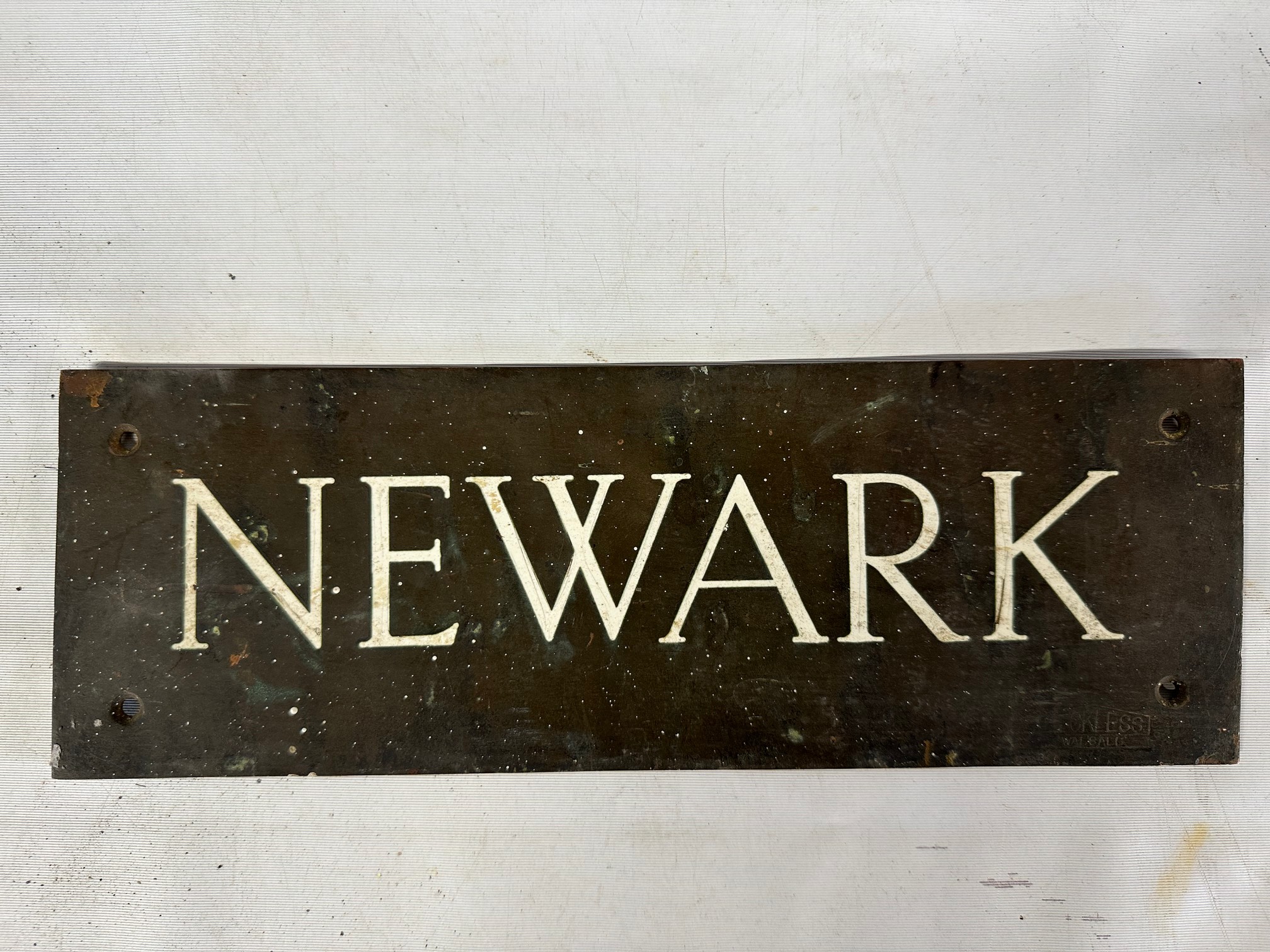A brass door plaque 'Newark', 10 1/2 x 3 1/2", with impressed stamp: Reckless, Walsall.