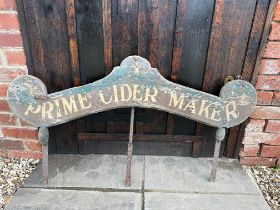 An unusual wooden advertising sign for Prime Cider Maker, with ornate wooden cider barrels to two of