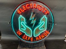 An illuminated neon lightbox, in excellent working condition, bearing the words 'Electricity in Safe