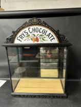 A chocolate shop display cabinet with two glass shelves with Fry's pediment to top and J.S. Fry &