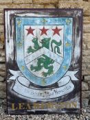 A pair of painted aluminium signs mounted back to back, advertising Leamington