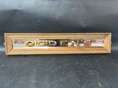 An Ogden's bevelled-edged etched mirrored advertising sign in wooden frame, 23 1/2 x 4 3/4".