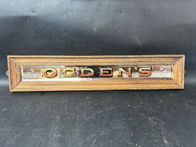 An Ogden's bevelled-edged etched mirrored advertising sign in wooden frame, 23 1/2 x 4 3/4".