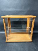 A glass tabletop display case with glass shelf, 18" wide x 17" tall x 10" deep.