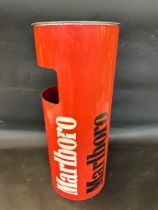 A cylindrical waste bin bearing Marlboro Formula 1 racing style advertising, circa 1980s, would make