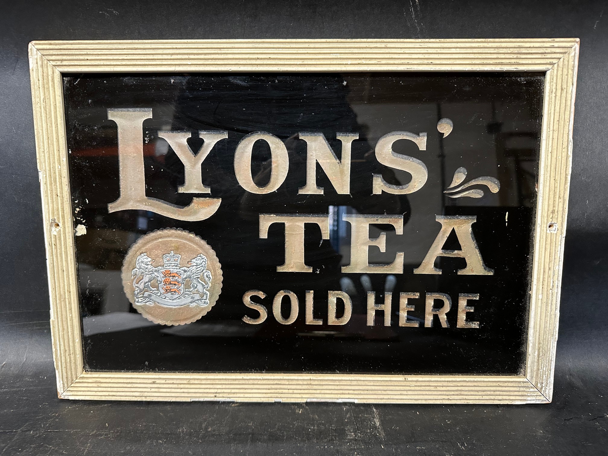 A Lyons' Tea Sold Here glass advertising sign, framed, 16 1/2 x 11 1/2".