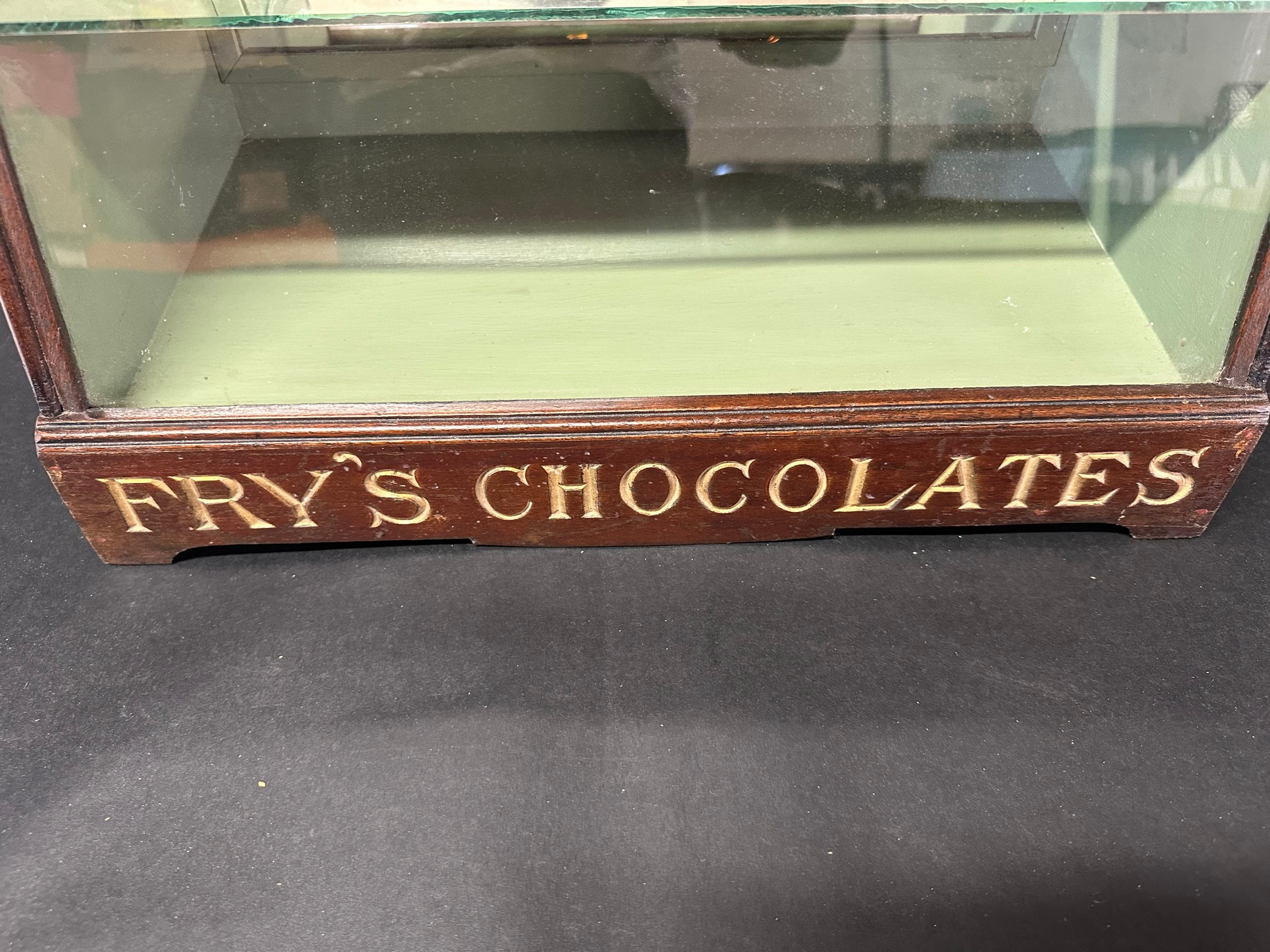 A Fry's Chocolates bowed glass cabinet with pediment, 25 1/2" tall x 9 1/2" deep x 17 3/4" wide. - Image 5 of 7