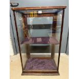 A glass display cabinet, 20 1/4" wide x 32 1/2" tall x 12 1/4" deep, glazing for rear door missing.