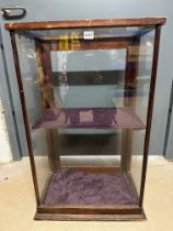 A glass display cabinet, 20 1/4" wide x 32 1/2" tall x 12 1/4" deep, glazing for rear door missing.