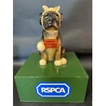 An RSPCA charity donation box with a dog dog to top, 12" tall.