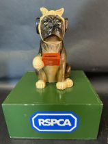 An RSPCA charity donation box with a dog dog to top, 12" tall.