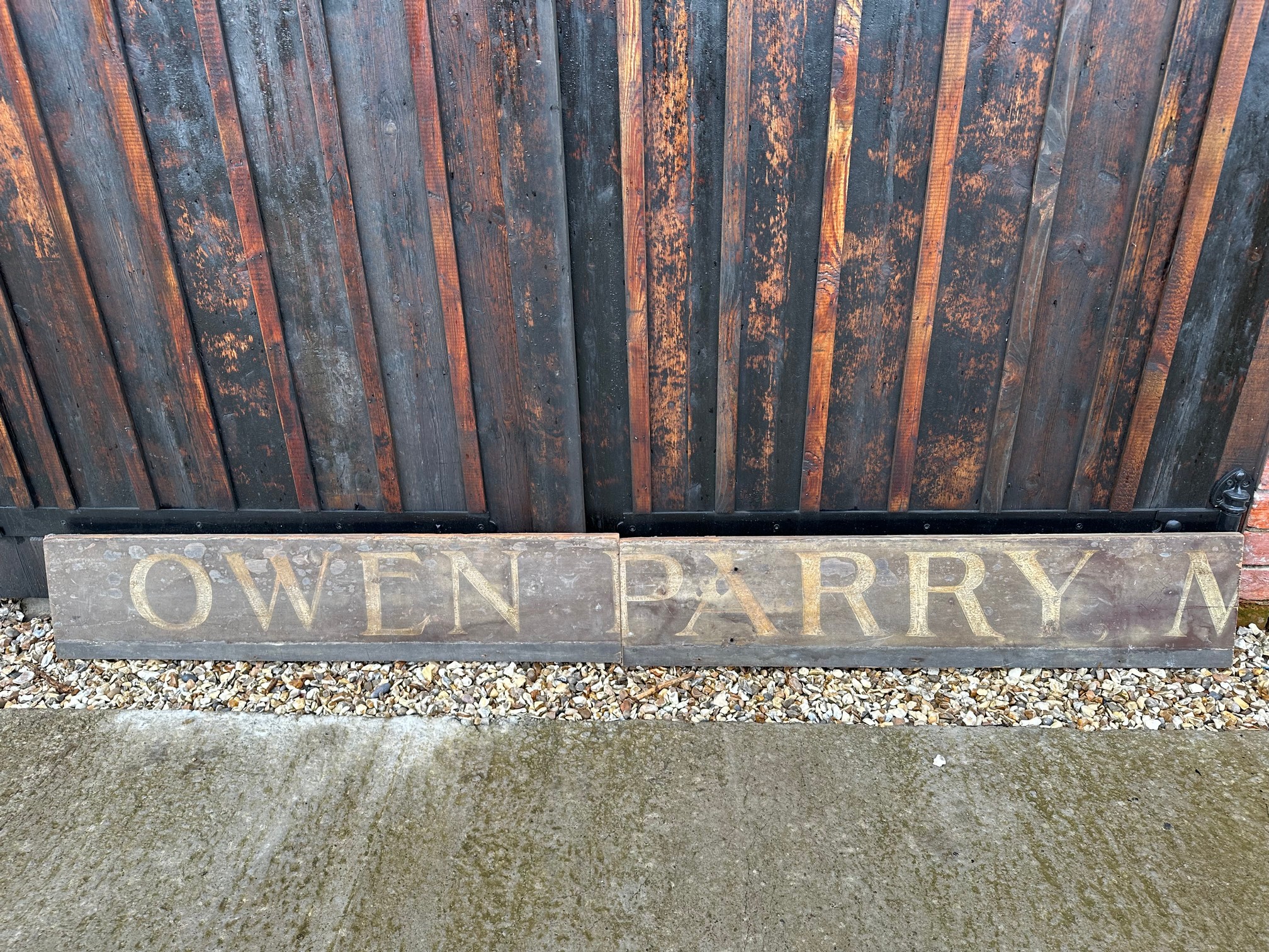 Two parts of a wooden hand painted Welsh advertising sign 'Owen Parry', 48 x 10 1/2" each.